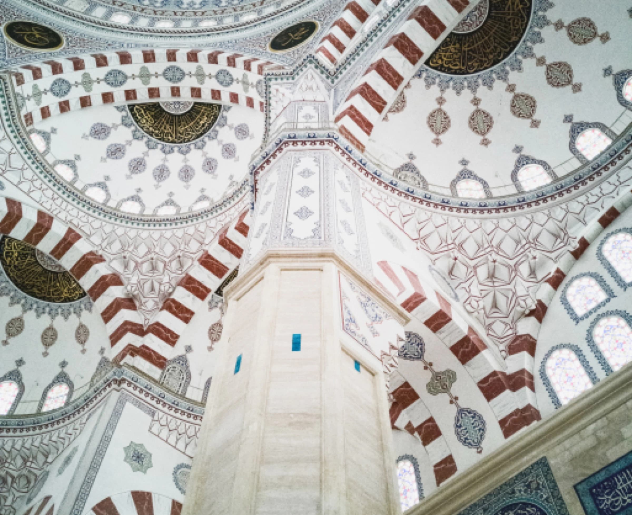 Painted domes and arches inside an Ottoman mosque
