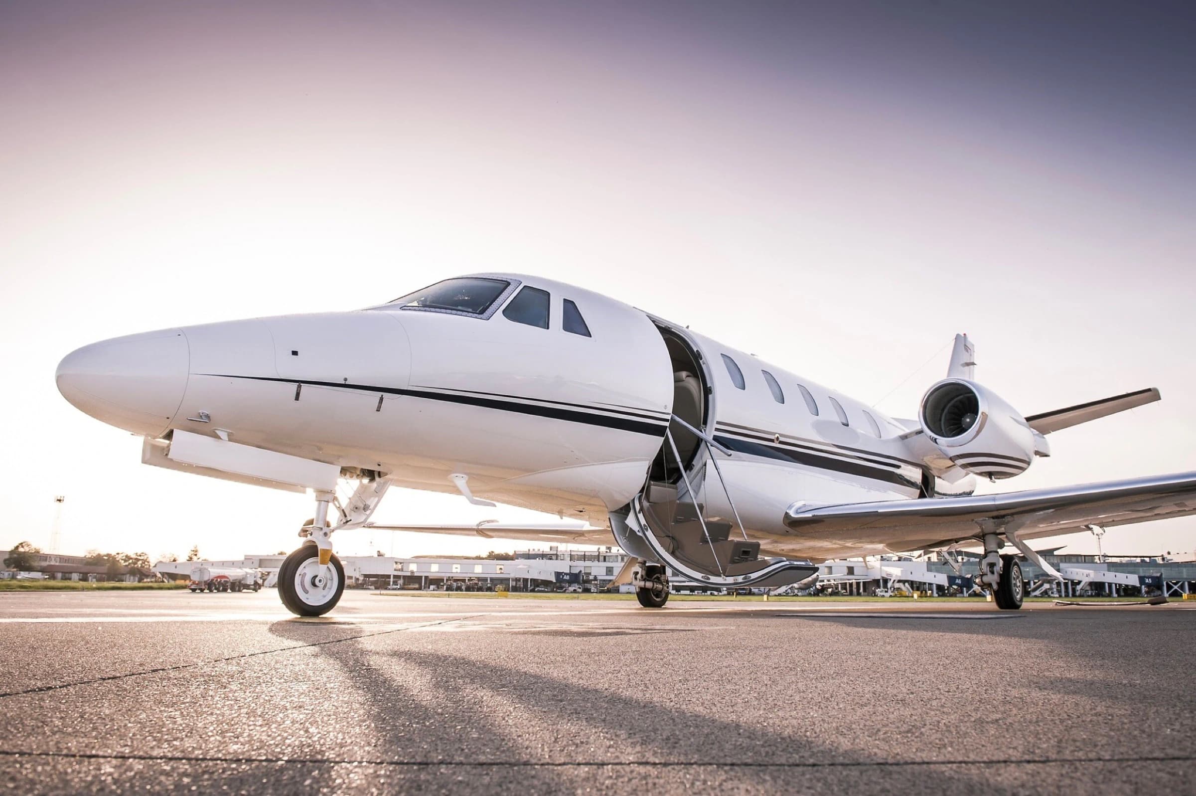 A private jet waiting on the tarmac at golden hour