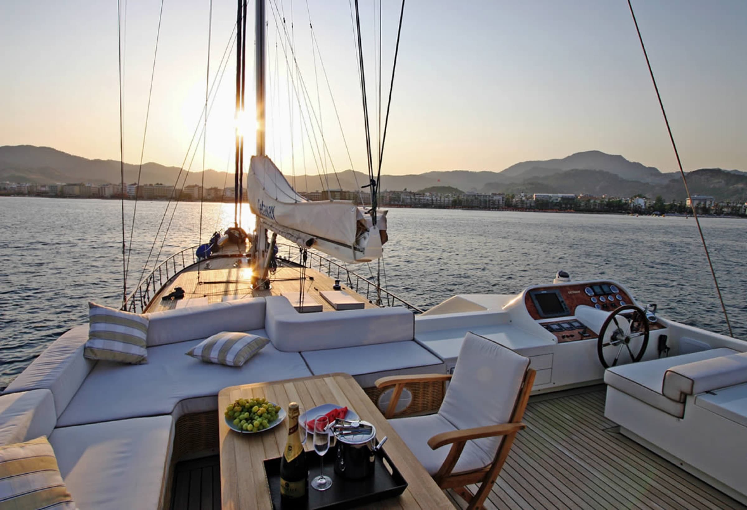 Champagne and fresh fruit set out on the sunset deck of a private gulet