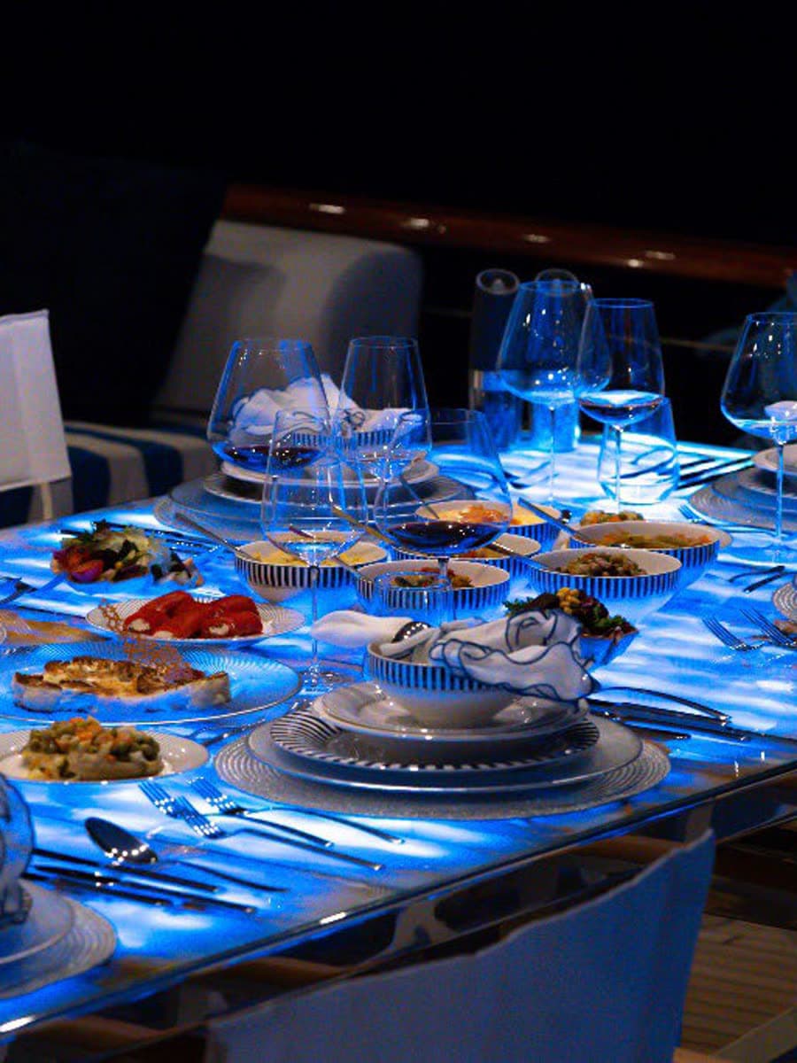 The marble table laid for dinner, glowing after dark
