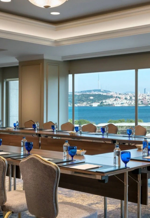 A boardroom with blue glassware overlooking the Bosphorus