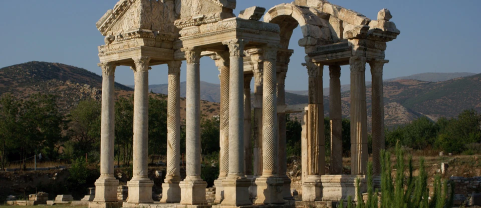 The monumental marble Tetrapylon gateway of Aphrodisias, backed by Anatolian hills.