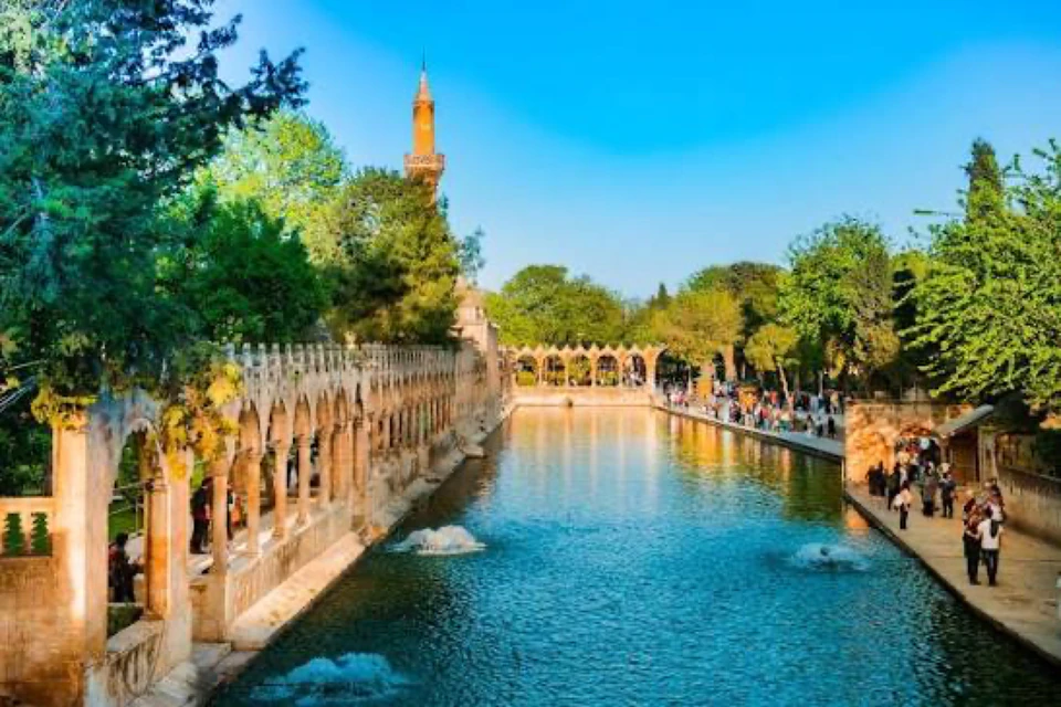 The sacred pool of Balıklıgöl lying mirror-still beneath its Ottoman colonnade in Şanlıurfa