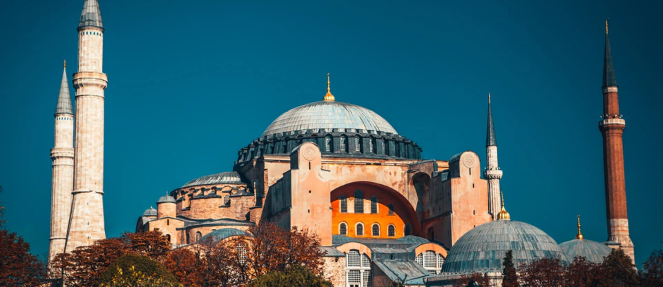 The great dome and minarets of St. Sophia (Hagia Sophia) against a deep blue sky.