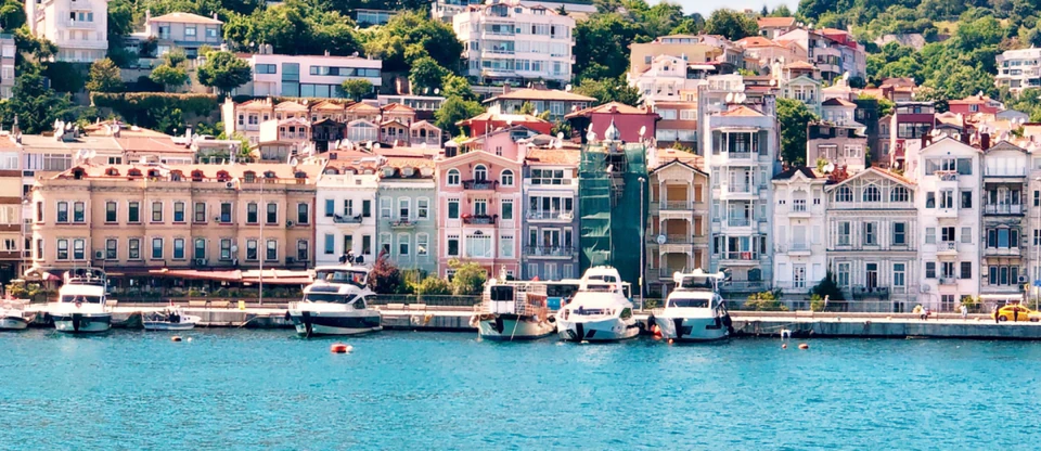 Pastel Ottoman-era houses and moored boats along the Arnavutkoy waterfront.
