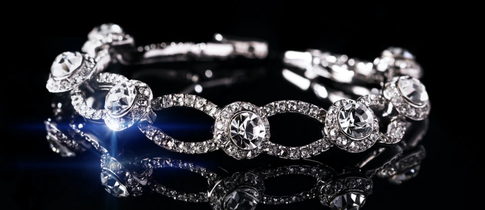 A handcrafted bracelet set with brilliant stones sparkling against a black background.