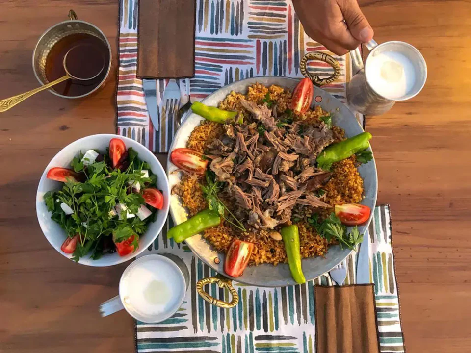 A south-eastern table laid with slow-cooked lamb, fresh greens, and Turkish coffee