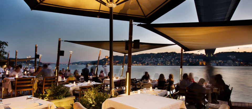 Waterside dining along the Bosphorus beneath Istanbul's evening glow