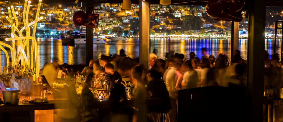 Bodrum's waterfront nightlife glowing in gold and blue across the bay