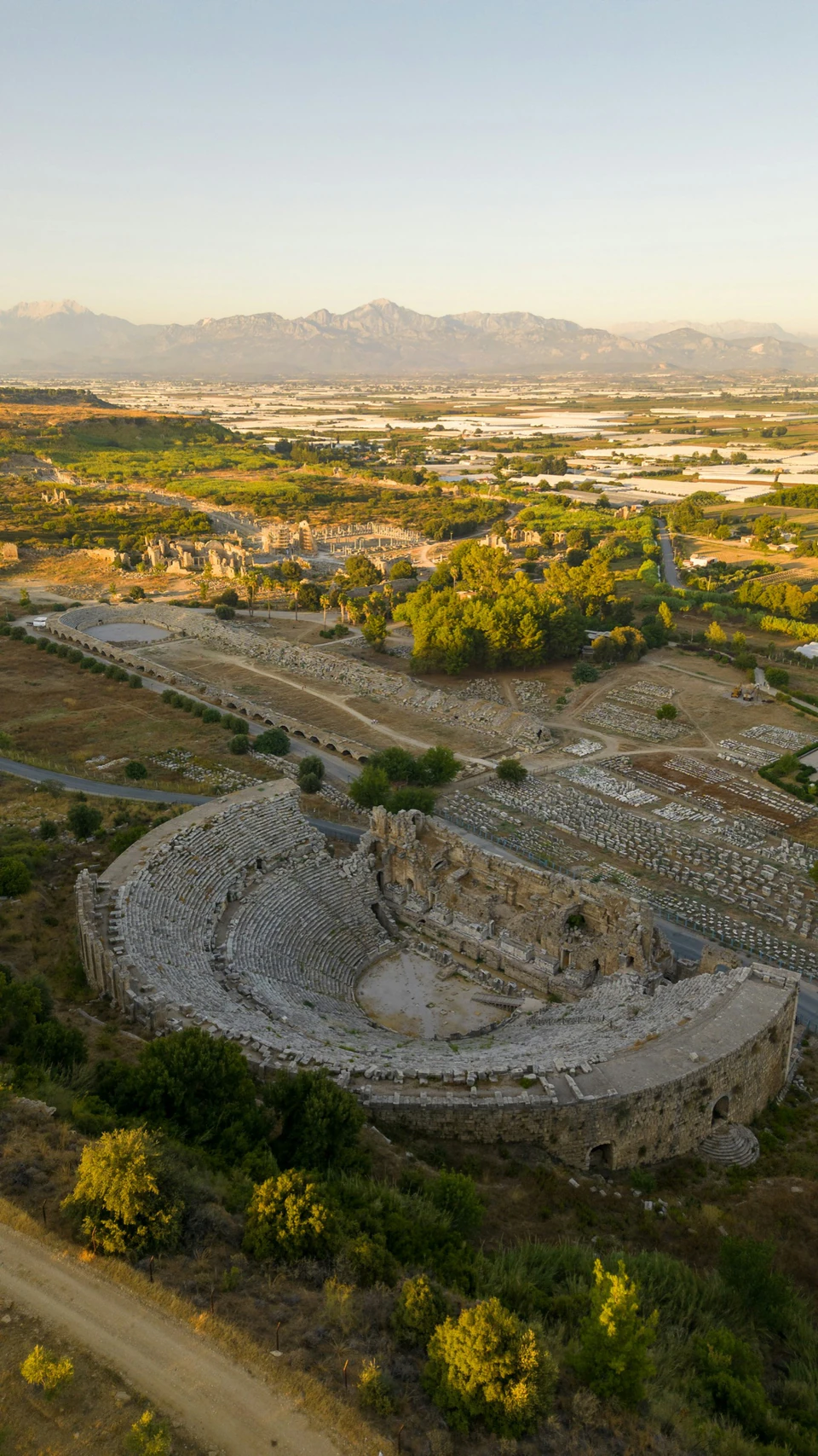 Aerial view over Perge's colonnaded avenue and the vaulted Roman stadium beside it