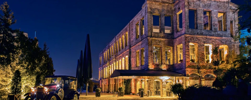 An illuminated historic waterfront venue at night
