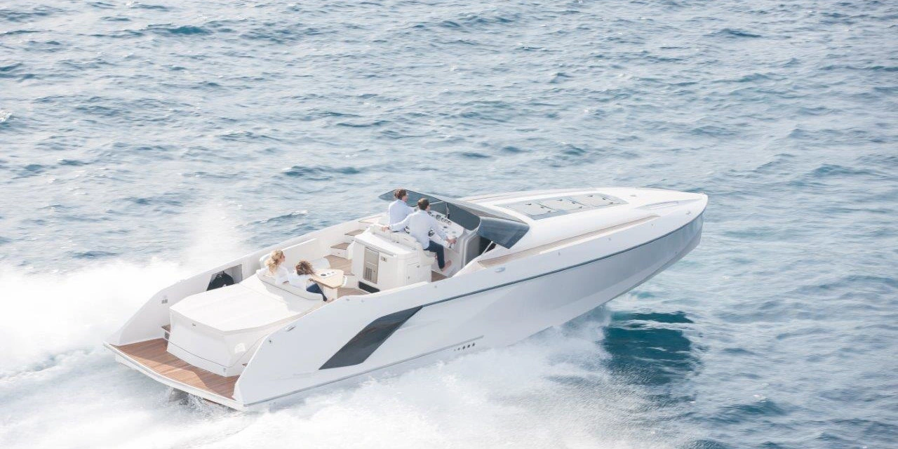 A white private speedboat travelling across open water